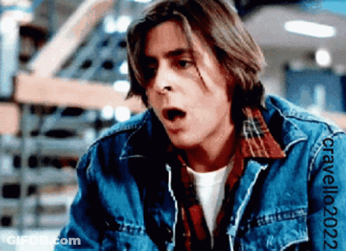 A Man Wearing A Denim Jacket And A Plaid Shirt Has The Year 2022 On The Sleeve Of His Jacket GIF