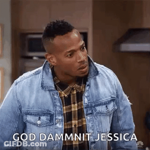 A Man Wearing A Denim Jacket And A Plaid Shirt Is Standing In A Kitchen . GIF