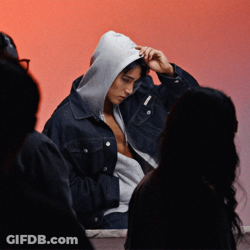 A Man Wearing A Denim Jacket With A Hood On His Head GIF