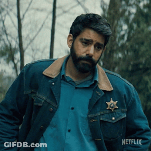 A Man Wearing A Denim Jacket With A Sheriff 'S Badge On His Chest GIF