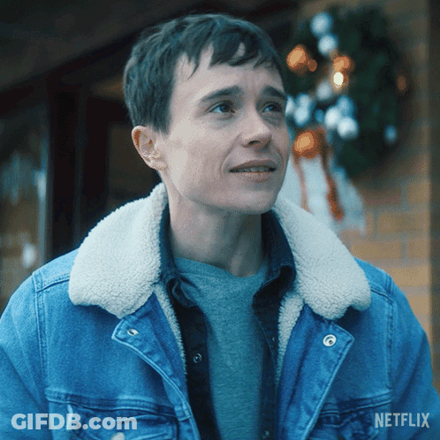 A Man Wearing A Denim Jacket With A Sherpa Collar And A Netflix Logo On The Bottom GIF
