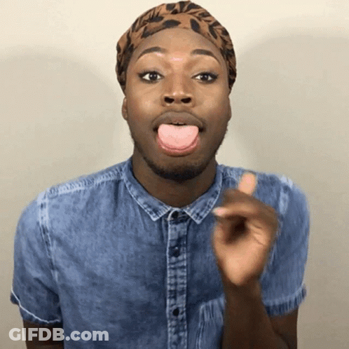 A Man Wearing A Denim Shirt And A Leopard Print Headband Is Sticking His Tongue Out GIF