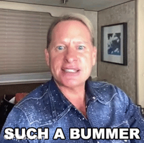 A Man Wearing A Denim Shirt Is Making A Funny Face And Says Such A Bummer . GIF