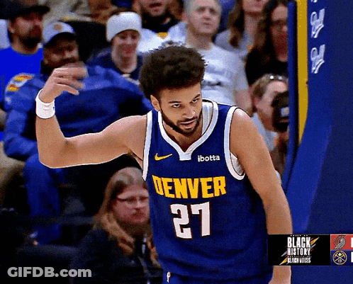 A Man Wearing A Denver Jersey Number 27 Stands In Front Of A Crowd GIF