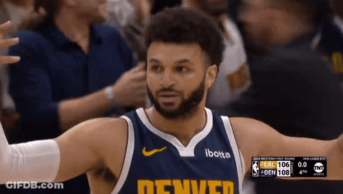 A Man Wearing A Denver Jersey Stands In Front Of The Crowd GIF