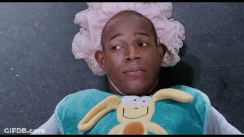 A Man Wearing A Diaper And Holding A Stuffed Bunny GIF