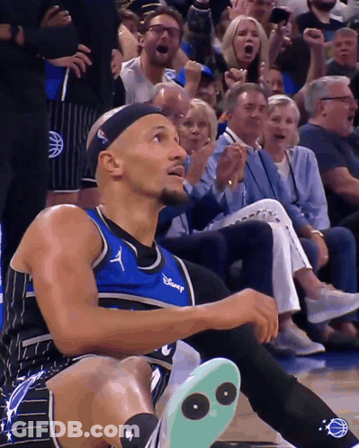 A Man Wearing A Disney Jersey Sits On The Floor GIF