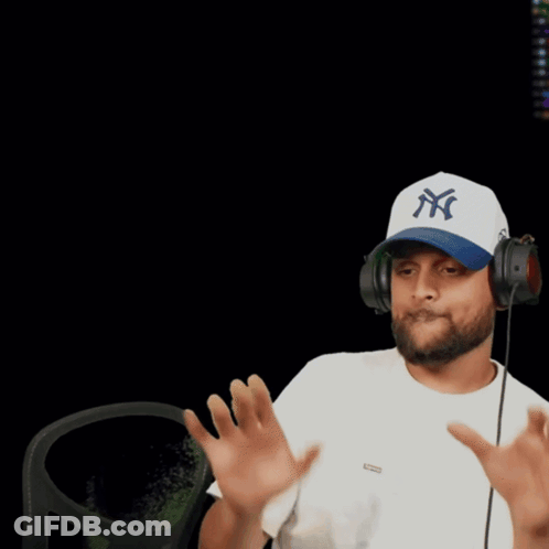A Man Wearing A Dodgers Hat Holds His Hands Up GIF