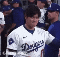A Man Wearing A Dodgers Jersey Stands In A Dugout GIF