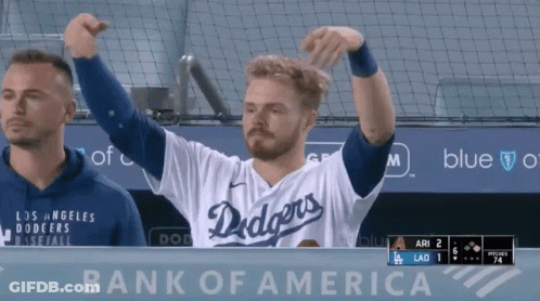 A Man Wearing A Dodgers Jersey Stands In Front Of A Bank Of America Sign GIF