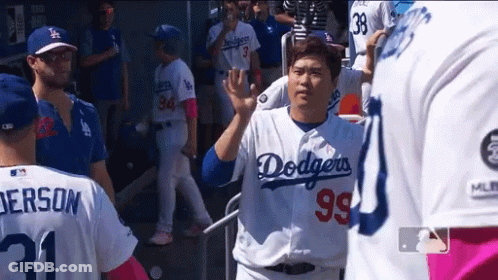 A Man Wearing A Dodgers Jersey Waves To A Fan GIF
