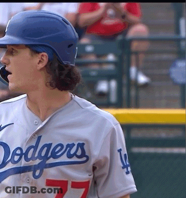 A Man Wearing A Dodgers Jersey With The Number 77 GIF