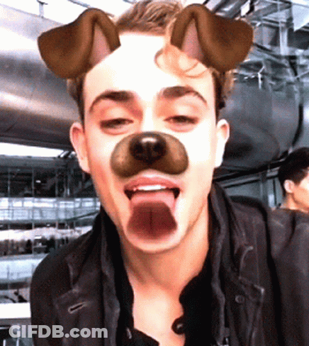 A Man Wearing A Dog Mask With His Tongue Sticking Out GIF