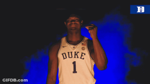A Man Wearing A Duke Jersey Is Pointing His Finger GIF