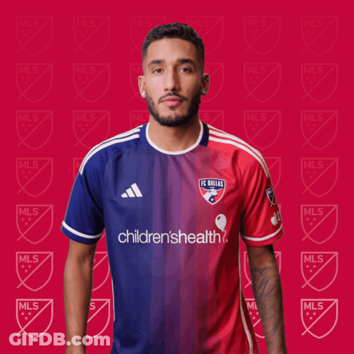 A Man Wearing A Fc Dallas Jersey Is Clapping His Hands GIF
