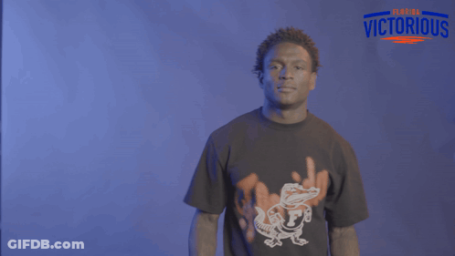 A Man Wearing A Florida Victorious Shirt Is Dancing GIF