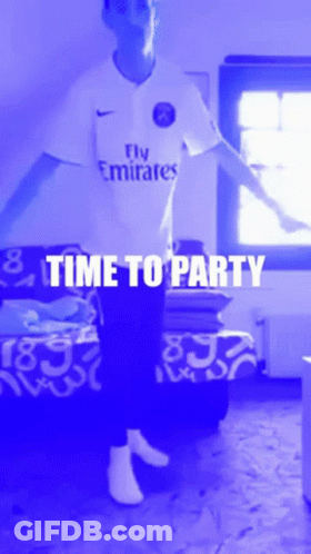 A Man Wearing A Fly Emirates Shirt Is Dancing In A Room GIF