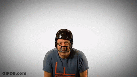 A Man Wearing A Football Helmet And A T-Shirt With A L On It GIF