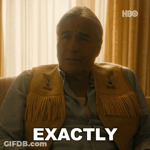 A Man Wearing A Fringed Vest Is Sitting On A Couch And Says Exactly GIF