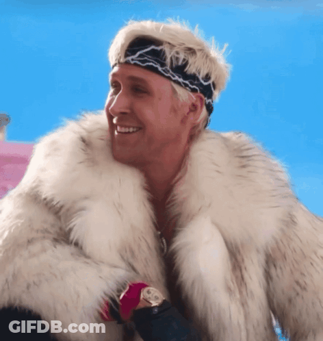 A Man Wearing A Fur Coat And A Headband Smiles GIF