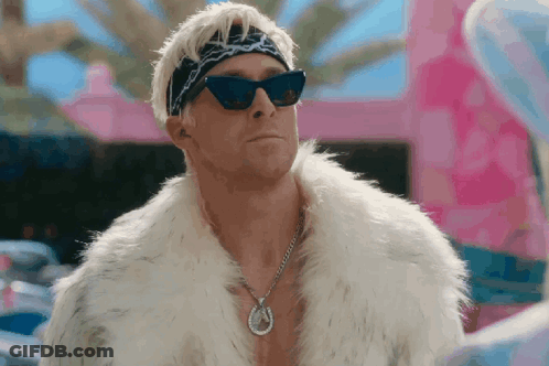 A Man Wearing A Fur Coat And Sunglasses Has A Horseshoe Necklace GIF