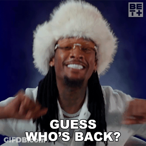 A Man Wearing A Fur Hat Is Smiling And Says Guess Who 'S Back GIF