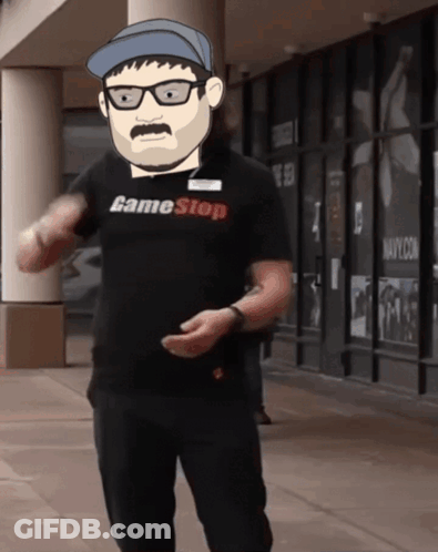 A Man Wearing A Game Stop Shirt Is Standing In Front Of A Building GIF