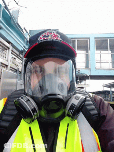 A Man Wearing A Gas Mask And A Hat That Says Ubc GIF