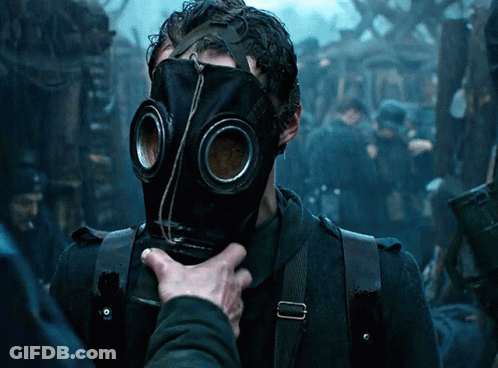 A Man Wearing A Gas Mask Is Being Touched By Another Man GIF