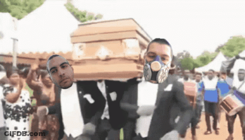 A Man Wearing A Gas Mask Is Carrying Another Man On A Coffin GIF