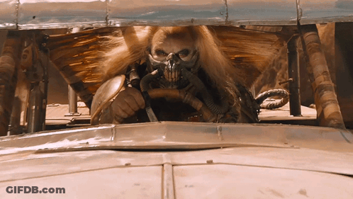 A Man Wearing A Gas Mask Is Driving A Vehicle GIF