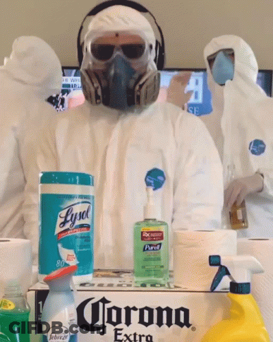 A Man Wearing A Gas Mask Is Standing Next To A Box Of Corona Extra GIF