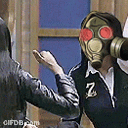 A Man Wearing A Gas Mask Is Standing Next To A Woman . GIF