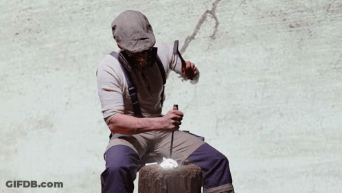 A Man Wearing A Gas Mask Sits In Front Of A Painting Of Hands Holding Money GIF