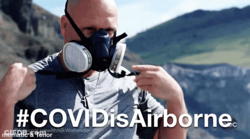 A Man Wearing A Gas Mask With The Hashtag #Covidisairborne On The Bottom GIF