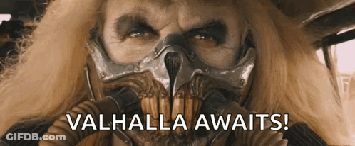 A Man Wearing A Gas Mask With The Words Valhalla Awaits On The Bottom GIF