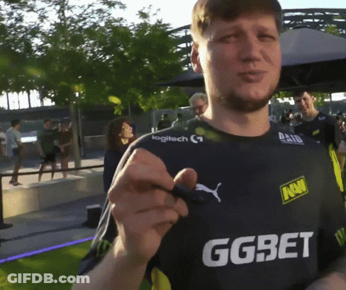 A Man Wearing A Ggbet Shirt Holds A Pen GIF