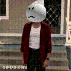 A Man Wearing A Ghost Mask Is Standing On A Set Of Steps GIF