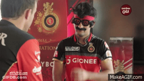 A Man Wearing A Gionee Shirt Is Talking To Another Man GIF