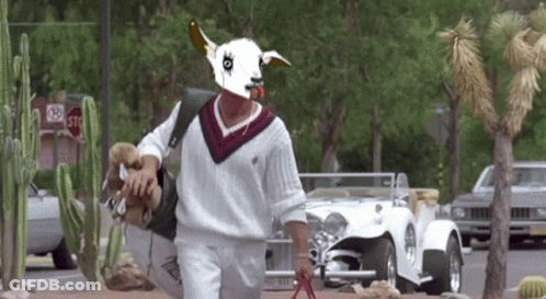 Man Wearing Goat Mask Walking Down Street GIF