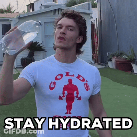 A Man Wearing A Gold 'S Gym T-Shirt Is Holding A Bottle Of Water GIF