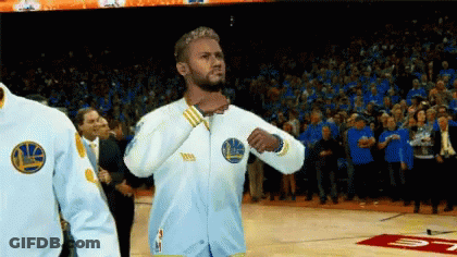 A Man Wearing A Golden State Warriors Jacket Stands On The Court GIF