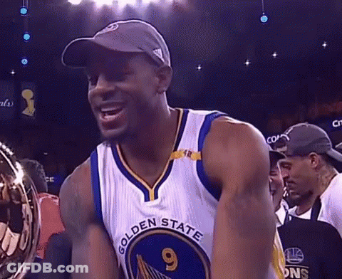A Man Wearing A Golden State Warriors Jersey Is Holding A Trophy . GIF