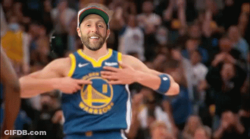 A Man Wearing A Golden State Warriors Jersey Is Pointing At His Chest . GIF