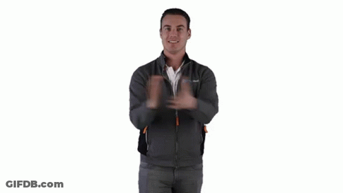 A Man Wearing A Gray Jacket Is Giving Two Thumbs Up . GIF