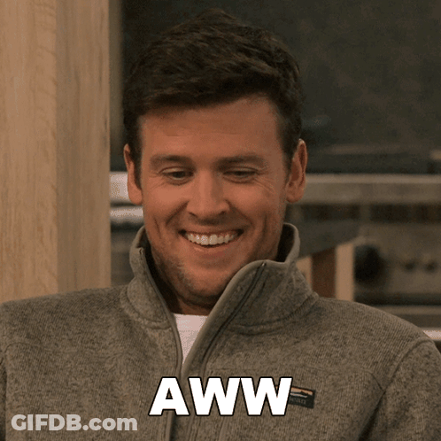 A Man Wearing A Gray Jacket With The Word Aww Written On It GIF