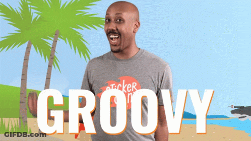 A Man Wearing A Gray Shirt That Says Groovy On It GIF