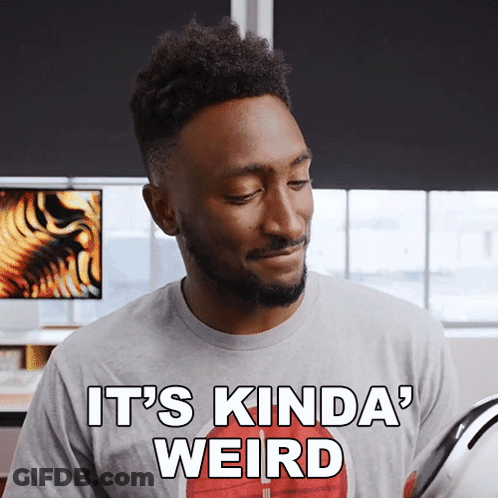 A Man Wearing A Gray Shirt That Says It 'S Kinda Weird GIF