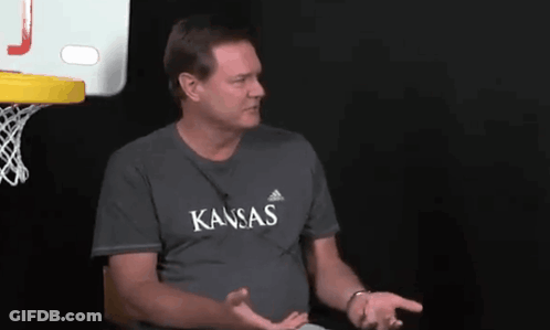 A Man Wearing A Gray Shirt That Says Kansas On It GIF
