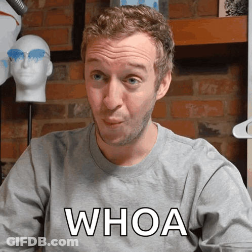 A Man Wearing A Gray Shirt That Says Whoa GIF